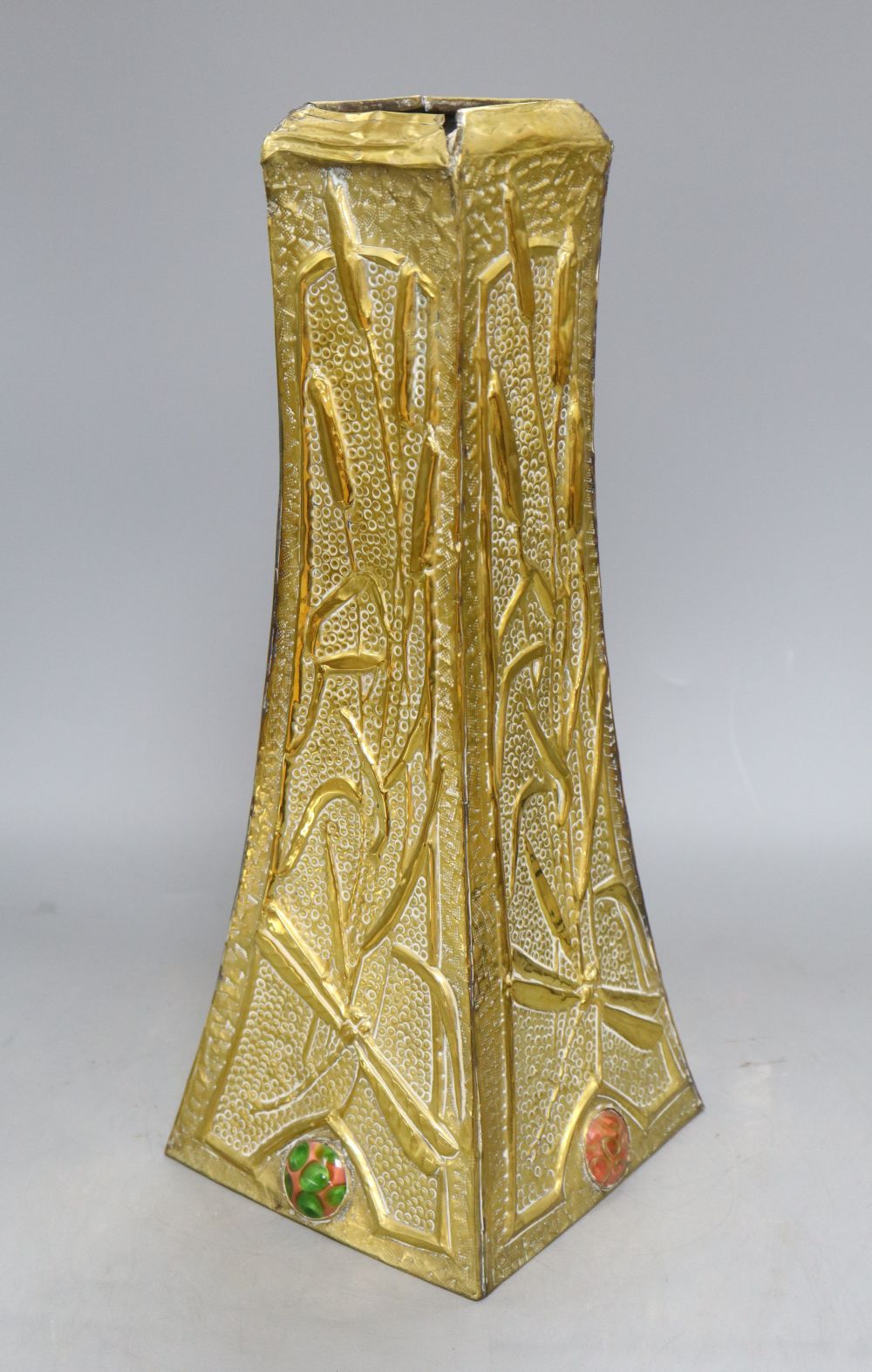 An Art Nouveau brass vase with multi coloured ceramic cartouches, height 40cm